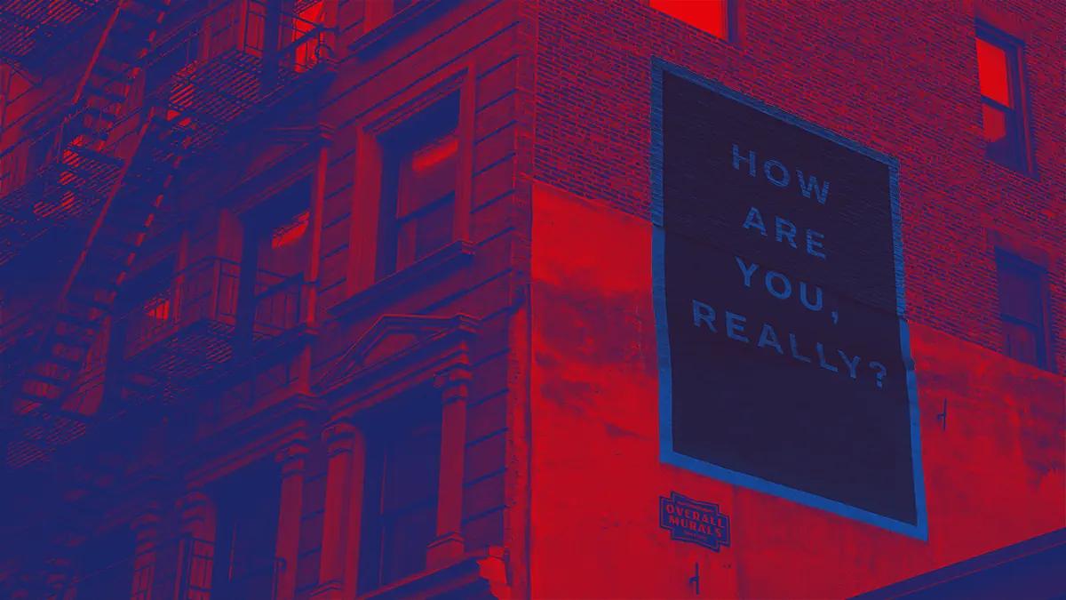 A building in red and a poster saying how are you really feeling