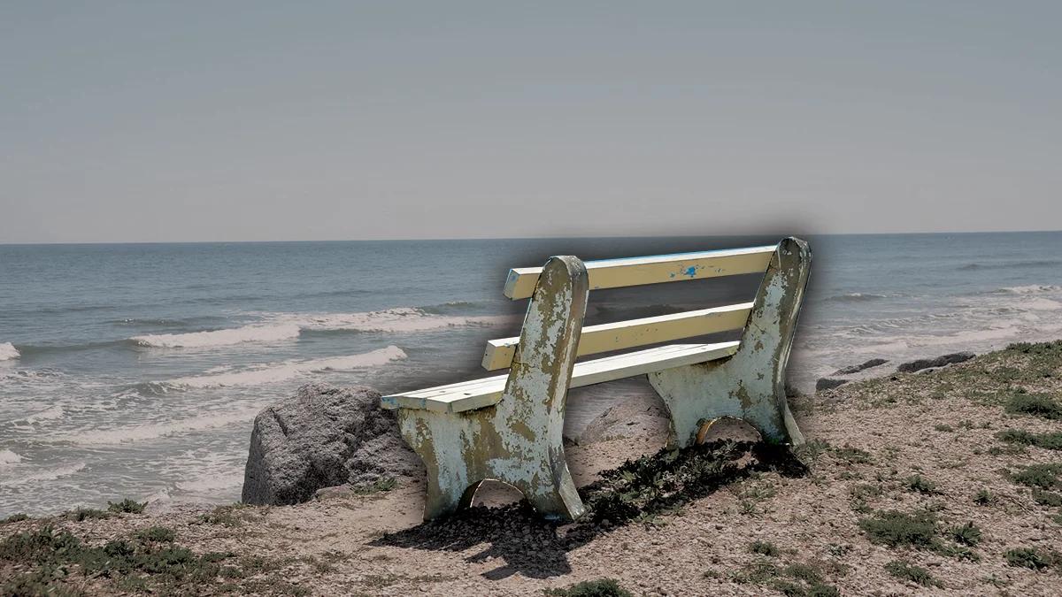 An empty bench facing the sea